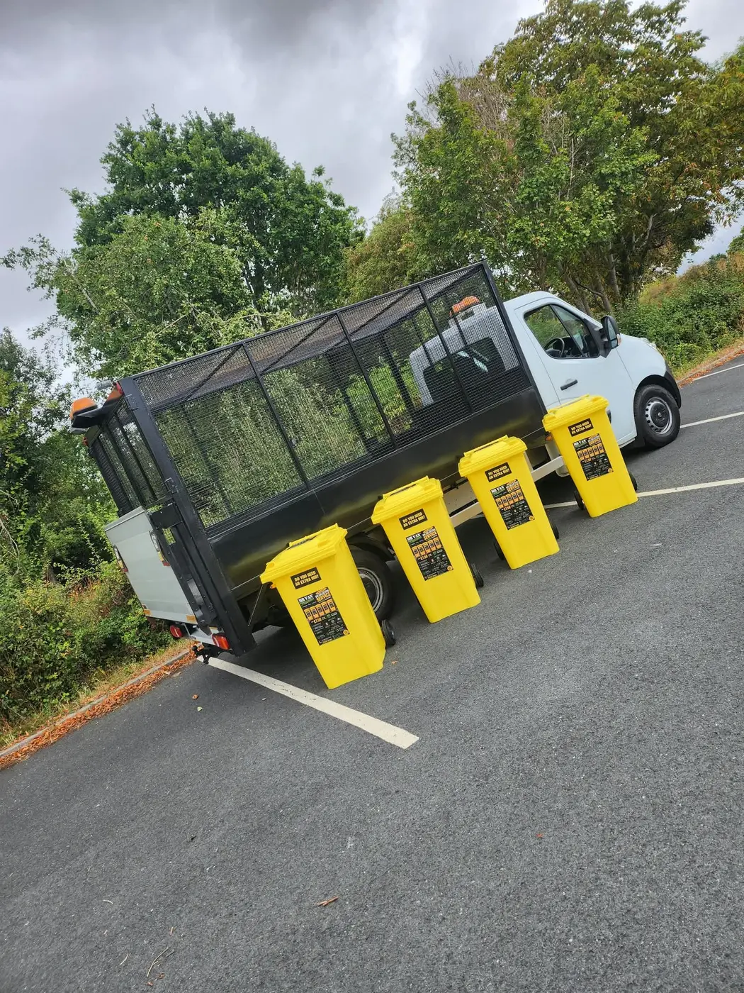 MR VAN Removals and Clearance cage vehicle beside four yellow bins on a Worcester collection round