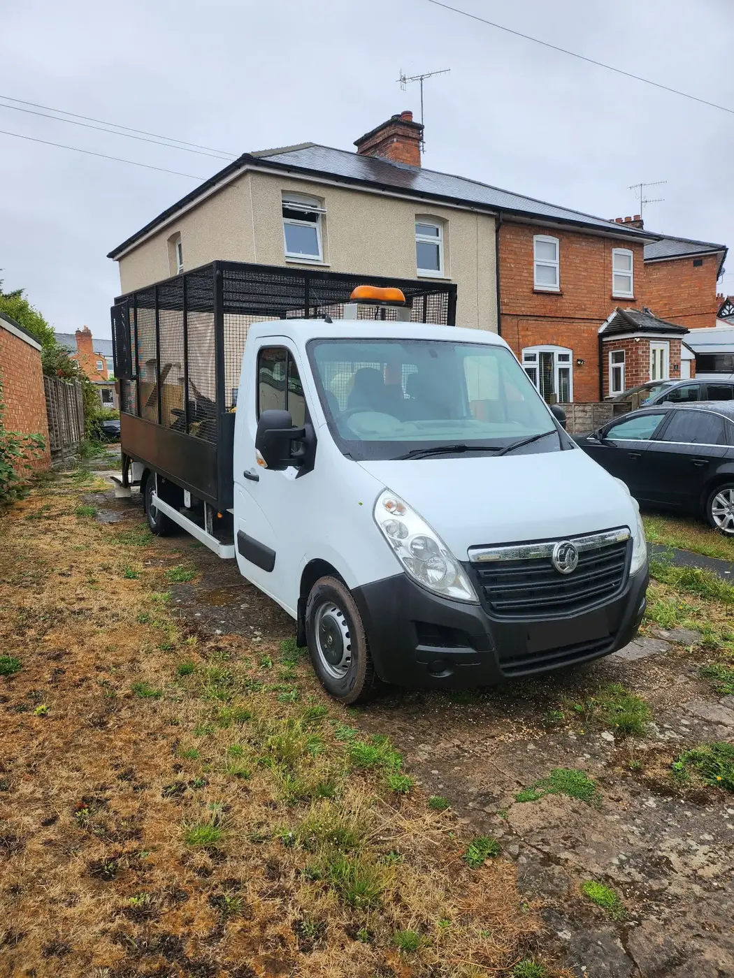 MR VAN Removals and Clearance cage truck parked outside a Worcester home for a clearance